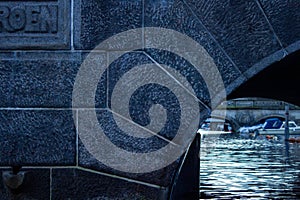 Detail of a stone arch bridge on a water canal in Copenhagen city. Denmark