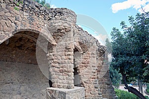 Detail of a stone walkway formed by arches in the Park Guell, made by the Spanish architect Gaudi.