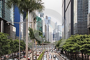 Detail of a street in central Hong Kong with many people walking on the street. On background local shops and restaurants