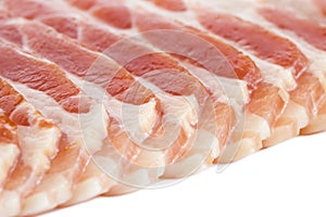 Detail of strips of streaky uncooked bacon.