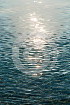 Detail of a sunlight reflecting in glittering sea. sparkler in water - background. sea water with sun glare and ripple