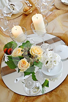 Detail of a table set in ocher color organza for a wedding banquet