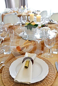 Detail of a table set in ocher color organza for a wedding banquet