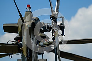 Detail of tail rotor of military helicopter, main rotor in background