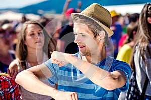 Detail of teenage boy at summer music festival dancing