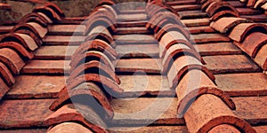 Detail of terracotta roof tiles. Aged photo.