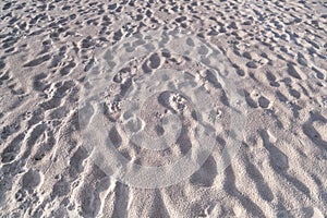 Detail texture of white sand Sea sun beach for relax in holiday Sunny summer background with foot print on sand beautiful beach in