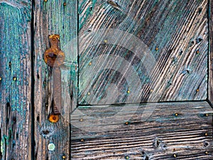 Detail of Textured Old Blue Painted Wooden Door