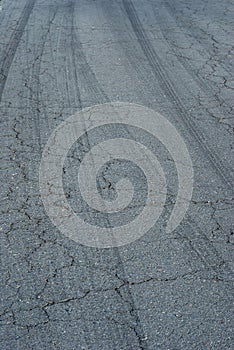 Detail of tire braking on rough asphalt in a dangerous vertical curve