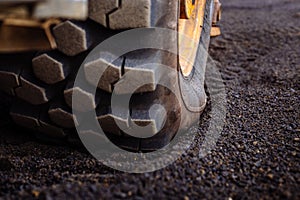 Detail on tire track pattern on a yellow heavy duty digger excavator