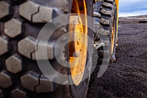 Detail on tire track pattern on a yellow heavy duty digger excavator