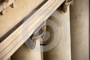 Detail from the top of an ionic column showing the presence of pigeon deterring spikes
