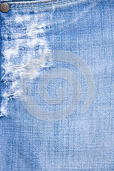 Detail of torn blue denim