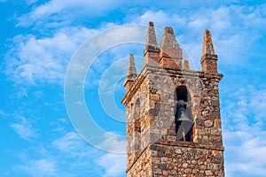 Detail of the tower bell, Monteriggioni, Tuscany, against blue sky
