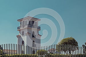 Detail of a tower of museum of costarican art in the capital of san jose on a sunny spotless cloud. White tower is seen rising up