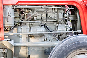 Detail of tractor machine or engine. Whit visible fuel pump, engine starter,