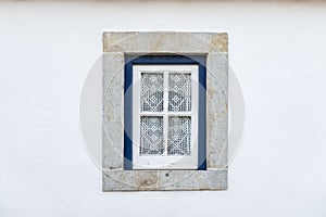 Detail of a traditional window on a white facade of a house