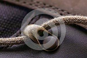 Detail of trekking shoes hook and loop for strap. Close-up photo of brown shoelaces on boot, shoe brass hooks