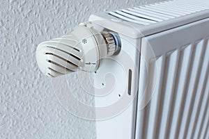 Detail of turned off thermostat, temperature knob of heating radiator. Saving energy and warm home concept, living costs