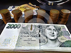 Detail of two hundred thousand Czech crowns in two thousand crowns banknotes stacked on a pile, in the background fifty crowns