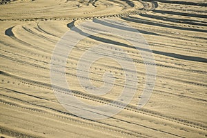 Detail of tyre tracks in sand desert