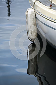 Detail of a used white tender on a boat lying idle in the water during corona virus pandemic  copy space