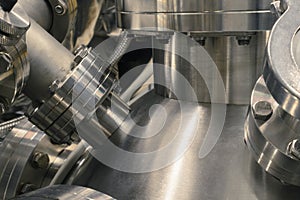 Detail of vacuum equipment with steel flanges bolted to the vessel in laboratory or industrial environment.