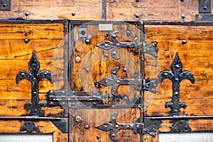 Detail of very ornate wrought iron hinges, locks and metal work on the timber exterior of a historic shop