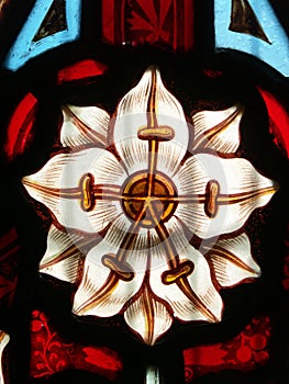 Detail of Victorian stained glass window showing white flower