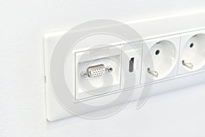 Detail view of an electrical outlet with hdmi connection mounted in interior of house on wall. House electronics tools.