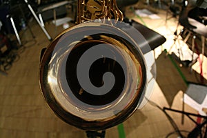 Detail view of golden big band instrument : saxophone bell . Sax Jazz instrument from birds eye perspective
