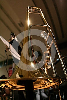 Detail view of golden big band instrument trombone. Trombone standing in frog perspective. T-Bone bell photographed from