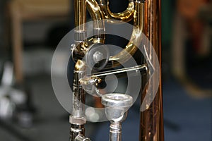 Detail view of golden big band instrument trombone. Trombone T-Bone Mouthpiece in detail. Macro close-up of the center of gravity