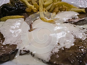 Detail view of a meat dish with roquefort sauce