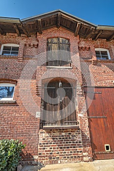 Detail view of an old farm. The facade is made of brick.