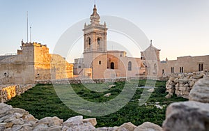 Detail view on the old, historical St. Joseph`s Chapel inside the Citadel of Victoria inside antique ruins walls with grass field