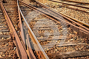 Detail view of a railroad crossing. Rusty train tracks.