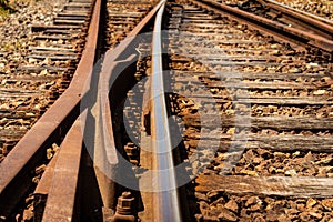 Detail view of a railroad crossing. Rusty train tracks.