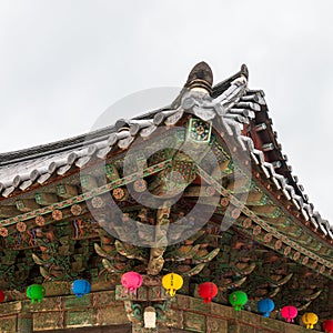 Detail view on roof of korean buddhist Bulguksa Temple with many lanterns to celebrate buddhas birthday on a clear day. Located in