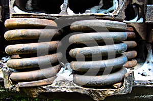 Detail view on a rusty springs of the old boxcar