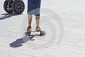 Detail view of skater boy legs on the skateboard. Close up