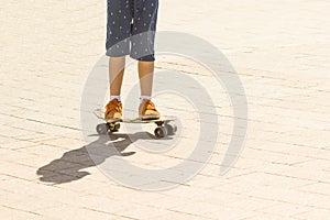 Detail view of skater boy legs on the skateboard. Close up
