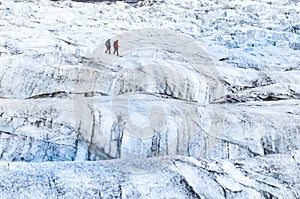 Detail view of two trekkers walking on the glacier, Vatnajokull photo