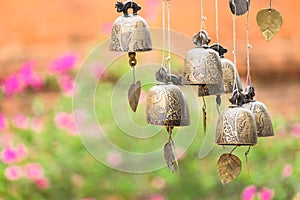 Detail view of vintage bronze bells with colorful bokeh