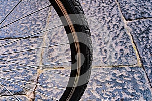 detail of vintage bike on stone paved road. wheel