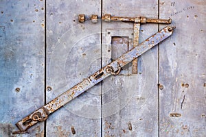 Detail of a vintage door with a rusty metal lock