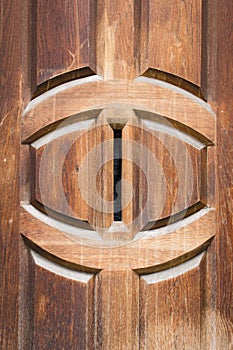 Detail of vintage solid wooden door with vertical postbox letter