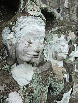 Detail of vintage stone face in the Bayon temple at Angkor Wat