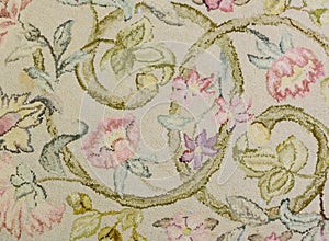 Detail of a vintage wool hooked rug with a botanical motiff with flowers