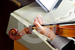 Detail of violin being played by child musician